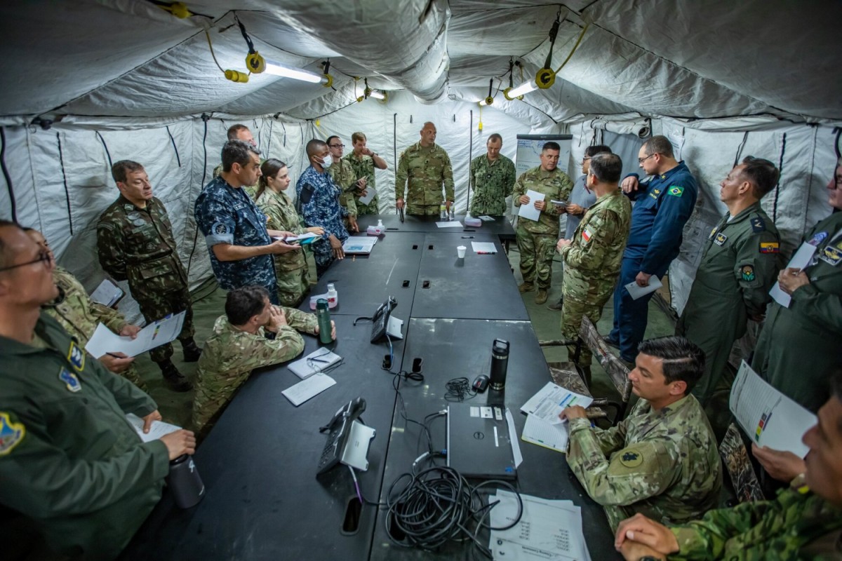 Military members from the U.S. and partner nation militaries conduct a briefing during PANAMAX 2022 on Joint Base San Antonio-Fort Sam Houston, August 4, 2022. PANAMAX 2022, a U.S. Southern Command-sponsored multinational command post exercise aimed at reinforcing and enhancing the long-term security of the Panama Canal and the Western Hemisphere, took place August 1-12, at bases in Texas, Florida, Virginia and Arizona. (U.S. Army photo by Spc. Joshua Taeckens) (Spc. Joshua Taeckens)