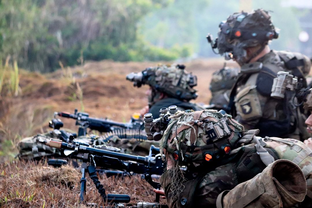 Brazilian and American troops work together to achieve objectives in a simulated war